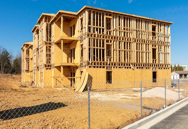 a close-up of temporary chain link fences enclosing a job site, signaling progress in the project's development in Golden Beach